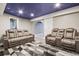Finished basement featuring theater seating, an archway, and a modern geometric rug at 19677 E Vassar Dr, Aurora, CO 80013