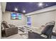 Basement theater room featuring reclining seats, a large screen, and dark blue ceiling at 19677 E Vassar Dr, Aurora, CO 80013