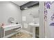 Classic bathroom with a pedestal sink, vanity table, and decorative mirror at 19677 E Vassar Dr, Aurora, CO 80013