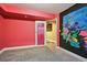 Vibrant bedroom showcasing unique artwork, colorful walls, and a doorway to another room at 19677 E Vassar Dr, Aurora, CO 80013