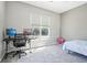 Neutral bedroom with a desk setup, a bed, and a window providing natural light at 19677 E Vassar Dr, Aurora, CO 80013