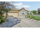 Charming home featuring stone accents and a spacious driveway leading to a two-car garage at 19677 E Vassar Dr, Aurora, CO 80013