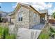 Attractive home with a stone facade and a well-maintained walkway leading to the front porch at 19677 E Vassar Dr, Aurora, CO 80013