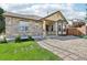 Attractive home showcasing a stone facade, bay window, and well-maintained front yard at 19677 E Vassar Dr, Aurora, CO 80013