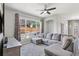 Comfortable living room with a large window, plush sectional sofa, and modern decor at 19677 E Vassar Dr, Aurora, CO 80013