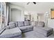 Cozy living room featuring a comfortable gray sectional sofa and a neutral color palette at 19677 E Vassar Dr, Aurora, CO 80013