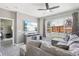 Cozy living room features a plush sofa, large windows, and stylish entertainment center at 19677 E Vassar Dr, Aurora, CO 80013