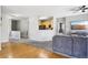 Inviting living space with hardwood and carpet flooring, leading to an open kitchen and living room at 19677 E Vassar Dr, Aurora, CO 80013