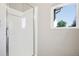 A bright shower stall featuring glass doors, tiled walls, and a window for natural light at 19677 E Vassar Dr, Aurora, CO 80013