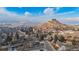 Expansive aerial shot of a residential area highlighting the city, mountain views, and the surrounding landscape at 597 Vista Dr, Castle Rock, CO 80104