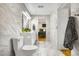 Beautiful bathroom features marble tile, a floating vanity and an open view into the bedroom at 597 Vista Dr, Castle Rock, CO 80104