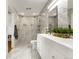 Modern bathroom with marble tile, double shower heads, and a floating double vanity at 597 Vista Dr, Castle Rock, CO 80104