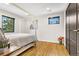 Bright bedroom with hardwood floors, lots of sunlight, and a modern accent wall at 597 Vista Dr, Castle Rock, CO 80104