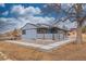 Stylish home showcasing modern design, a covered porch with lighting, and inviting landscaping with stone pavers at 597 Vista Dr, Castle Rock, CO 80104