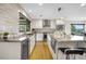 Well-lit kitchen with white cabinets, granite countertops, stainless steel appliances, and hardwood flooring at 597 Vista Dr, Castle Rock, CO 80104