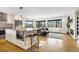 Bright living room and kitchen featuring modern white cabinets, granite countertops, and a view of the landscape at 597 Vista Dr, Castle Rock, CO 80104