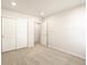 Neutral bedroom with carpeted floors, a double door closet and doorway into another room at 6581 N Malaya St, Aurora, CO 80019