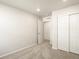 Neutral bedroom with carpeted floors, a double door closet, and a doorway into another room at 6581 N Malaya St, Aurora, CO 80019