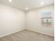 Neutral bedroom with carpeted floors, a window bringing in natural light and recessed lighting at 6581 N Malaya St, Aurora, CO 80019