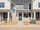 Charming townhome showcasing a stone facade, gray wood siding, and a welcoming front porch at 6581 N Malaya St, Aurora, CO 80019