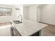 Kitchen island boasts granite countertops, stainless sink, and modern faucet at 6581 N Malaya St, Aurora, CO 80019