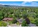 High-angle view of an upscale neighborhood surrounded by mature trees and lush landscaping at 12135 W Applewood Knolls Dr, Lakewood, CO 80215