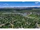 Scenic aerial shot featuring a lake, neighborhood, and mountain range under a blue sky at 12135 W Applewood Knolls Dr, Lakewood, CO 80215