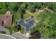 Bird's-eye view of a well-maintained home nestled among mature trees, showcasing its unique architecture at 12135 W Applewood Knolls Dr, Lakewood, CO 80215