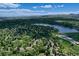 Breathtaking aerial view showcasing a tranquil lake, residential area, and distant mountains at 12135 W Applewood Knolls Dr, Lakewood, CO 80215
