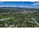 Panoramic aerial view of a residential area with a beautiful mountain range backdrop at 12135 W Applewood Knolls Dr, Lakewood, CO 80215