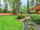 Landscaped backyard featuring stone steps and lush greenery, offering a serene outdoor space at 12135 W Applewood Knolls Dr, Lakewood, CO 80215
