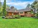 Manicured backyard with rock features and covered patio, perfect for entertaining at 12135 W Applewood Knolls Dr, Lakewood, CO 80215