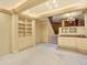 Basement area with built-in bookshelves, a fireplace, and access to stairs at 12135 W Applewood Knolls Dr, Lakewood, CO 80215