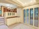 Basement area with a serving counter, access to stairs, and sliding glass doors at 12135 W Applewood Knolls Dr, Lakewood, CO 80215