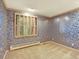 Bedroom with blue patterned wallpaper and a window with wood blinds at 12135 W Applewood Knolls Dr, Lakewood, CO 80215