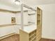Spacious walk-in closet with custom shelving and drawers for optimal organization at 12135 W Applewood Knolls Dr, Lakewood, CO 80215
