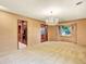 Open dining room features a chandelier, bay window, and seamless kitchen access at 12135 W Applewood Knolls Dr, Lakewood, CO 80215