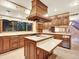 Traditional kitchen with wood cabinets, an island cooktop, and large picture window at 12135 W Applewood Knolls Dr, Lakewood, CO 80215