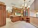 An expansive kitchen with custom cabinets, a central island, and an adjacent desk area at 12135 W Applewood Knolls Dr, Lakewood, CO 80215