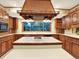 Bright kitchen featuring custom wood cabinetry, a tile island, and large windows at 12135 W Applewood Knolls Dr, Lakewood, CO 80215