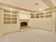 Cozy living room with a brick fireplace and built-in cabinets and shelving at 12135 W Applewood Knolls Dr, Lakewood, CO 80215