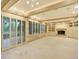 Large living room with fireplace, built-in shelves, and large sliding glass doors at 12135 W Applewood Knolls Dr, Lakewood, CO 80215