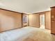 Spacious living room features neutral walls, plush carpeting, and a view to the en-suite bathroom at 12135 W Applewood Knolls Dr, Lakewood, CO 80215