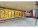 Covered brick patio with large windows, creating a sunroom feel for outdoor enjoyment at 12135 W Applewood Knolls Dr, Lakewood, CO 80215