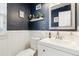 Stylish powder room with white vanity and dark blue walls at 5630 Spruce Ave, Castle Rock, CO 80104