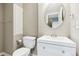 Basement bathroom with white vanity and round mirror at 5630 Spruce Ave, Castle Rock, CO 80104