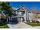 Two-story house with gray siding, landscaped yard, and a two-car garage at 5630 Spruce Ave, Castle Rock, CO 80104