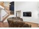 Living room with hardwood floors, sectional sofa, and large TV at 5630 Spruce Ave, Castle Rock, CO 80104