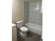 Cozy bathroom featuring a marble-tiled shower-tub combo and modern toilet at 14602 E 2Nd Ave # 108-C, Aurora, CO 80011