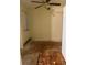 Empty bedroom featuring a ceiling fan, window, and worn floors ready for customization at 14602 E 2Nd Ave # 108-C, Aurora, CO 80011